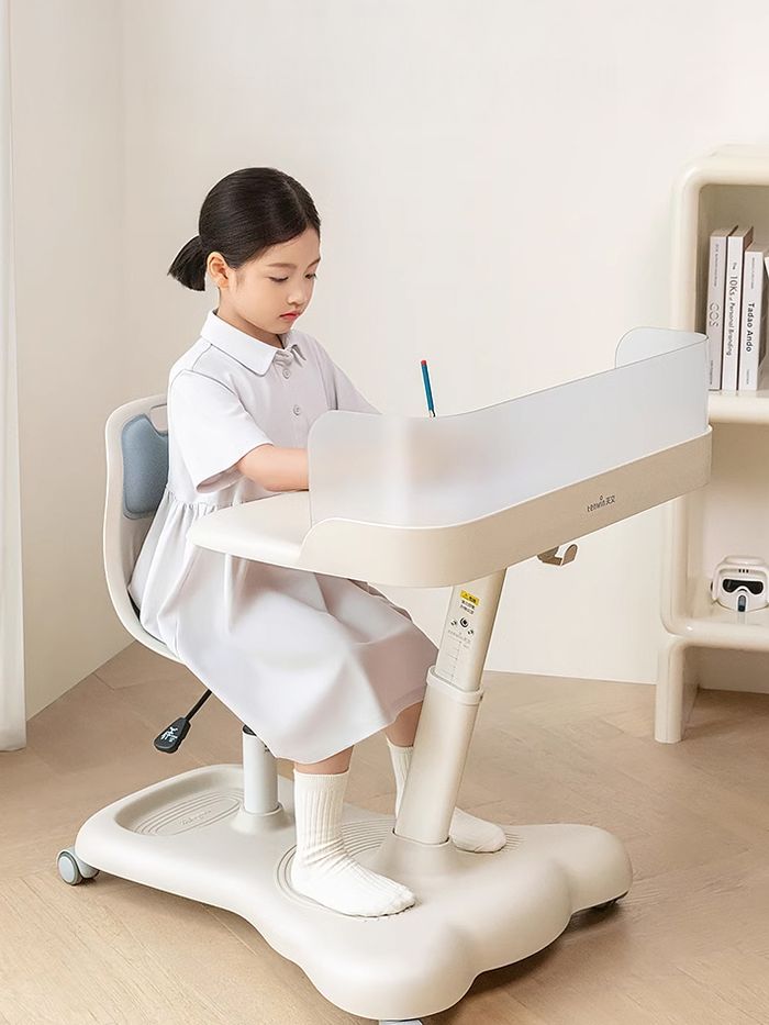 Bàn ghế học di động màu kem, bé đang ngồi học